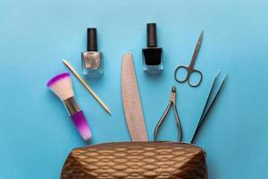 Top view of manicure and pedicure equipment on blue background photo