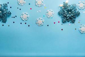 Christmas or winter composition. Pattern made of snowflakes on pastel blue background. photo