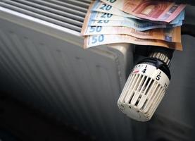 Controlling the heating costs - radiator control and Euro bills on the central heating photo