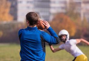 american football team with coach in action photo