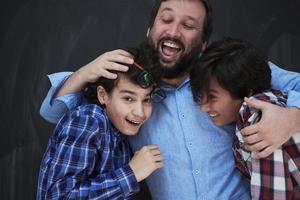 happy father hugging sons photo