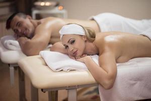 young couple lying on massage table photo