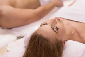 young couple lying on massage table photo