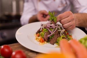 cook chef decorating garnishing prepared meal photo