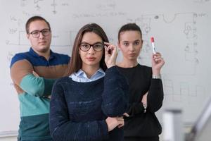 portrait of young students in front of chalkboard photo