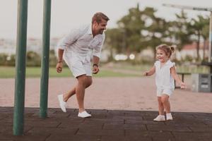 An elderly man in casual clothes with his daughter spends time together in the park on vacation. Family time. Selective focus photo