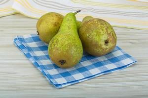 Ripe pears on wooden background photo
