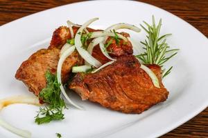 Shashlik on the plate and wooden background photo