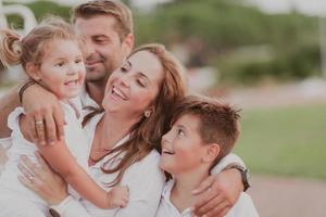 Senior couple in casual clothes with their children spending time in park a vacation together. Family time . Selective focus photo