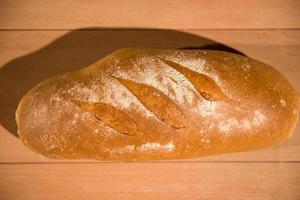 fresh bread on wooden table photo