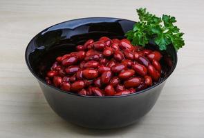 Baked beans in a bowl on wooden background photo