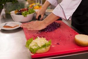 chef cutting salad for burger photo