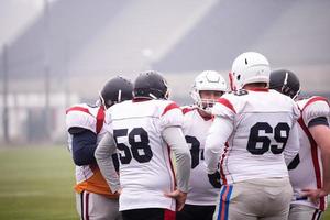 american football players discussing strategy photo