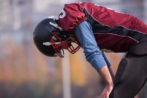 american football player resting after hard training photo