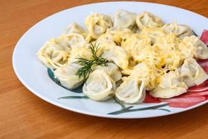 Russian dumplings on the plate and wooden background photo