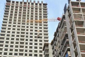 Crane and building construction site. Industry new civil house business. Development concept. Architecture planning of a city. Renovation project. photo