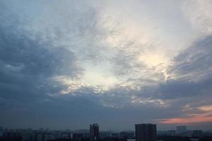 Colorful cloudy twilight beautiful sky cityscape sunset and morning sunrise. Dramatic evening night early morning view with city buildings silhouette. Panoramic background concept. Copy space for text photo