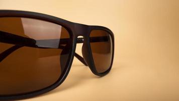 sun polarized safety glasses closeup on beige background photo