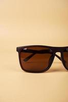 brown solar polarized safety glasses closeup on a beige background photo