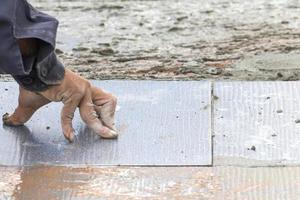 Mason repairing the tiles photo