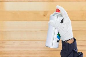 Hand holding spray paint can photo