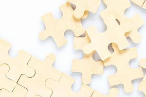 wooden jigsaw puzzle pieces on white background photo