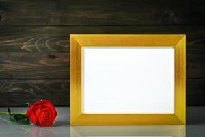 Picture mock up with golden frame on table with copy space photo