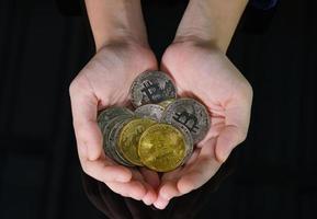 Bitcoin coins in the hand of a  women photo
