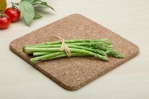 Asparagus on wooden board and wooden background photo