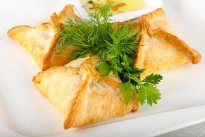 Samosa on the plate on white background photo