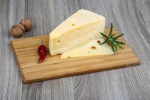 Yellow cheese on wood photo