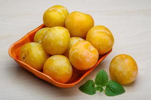 Yellow plums in a bowl photo