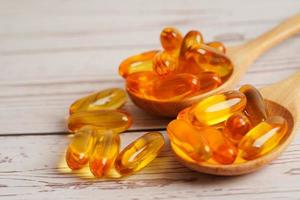 Fish oil or Cod liver oil gel in capsules with omega 3 vitamins, supplementary healthy food photo