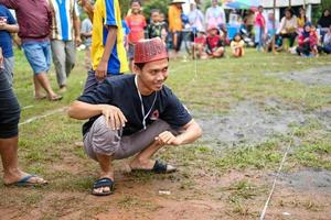 Blitar, Indonesia - September 11th 2022 Enthusiastic teenage boys take part in a competition to commemorate Indonesian Independence Day in Blitar in the afternoon photo