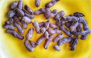 Boiled peanuts on a yellow plate. photo