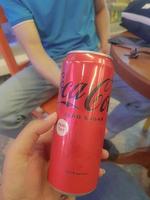 Jakarta, Indonesia in July 2022. A hand is holding a can of fizzy drink, coca - cola zero sugar. photo