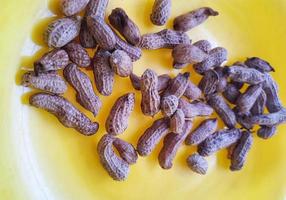 Boiled peanuts on a yellow plate. photo