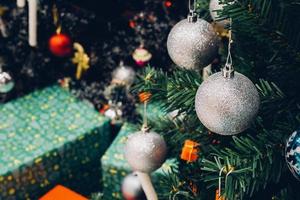 Decorated Christmas tree with colorful bauble on sparkling bokeh light blurred background photo