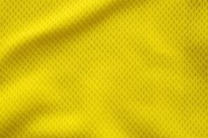 Yellow color football jersey clothing fabric texture sports wear background, close up photo