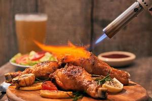 Chef cooking of Crispy Fried Chicken on wooden board background in the restaurants. Foods concept. Warm lights tone. photo