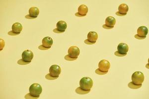 Flat lay pattern of fresh Calamondin or citrus microcarpa on a colorful background. Top view - Image photo