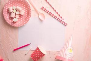 Party management and organization concept with sweets, confetti and blank pages. Creative celebration flat lay with copy space. photo