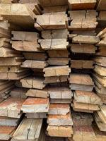 irregularly stacked timber abstract background, Old wooden boards preparing for the construction of the house, Pattern on the edge of several pieces of wood.mobile photo