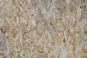 Background texture surface OSB plywood or Oriented Strand Board, recycled material from waste wood. photo