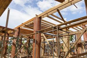 Scaffolding structure for the construction of a wooden house photo