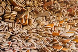 irregularly stacked timber abstract background, Old wooden boards preparing for the construction of the house, Pattern on the edge of several pieces of wood photo