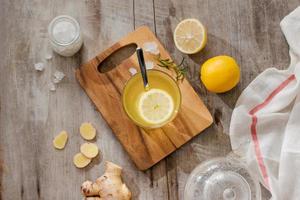 refreshing citrus lemonade,summer drink. Lemonade with fresh lemon on wooden background photo