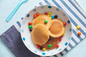 Children's breakfast or dessert - pancake with colorful candies. photo