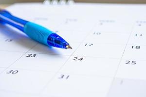 Blue pen on calendar page background business planning appointment meeting concept photo