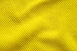 Yellow color football jersey clothing fabric texture sports wear background, close up photo